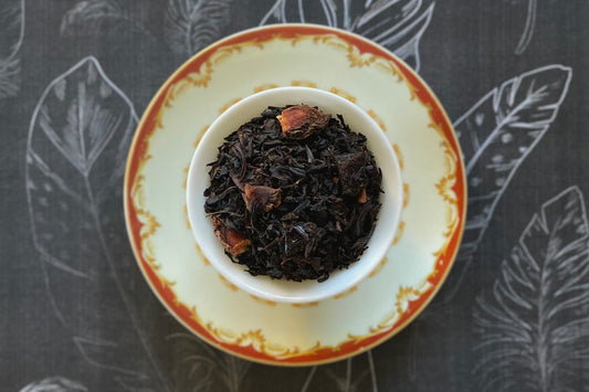 Teacup full of black tea leaves and star anise