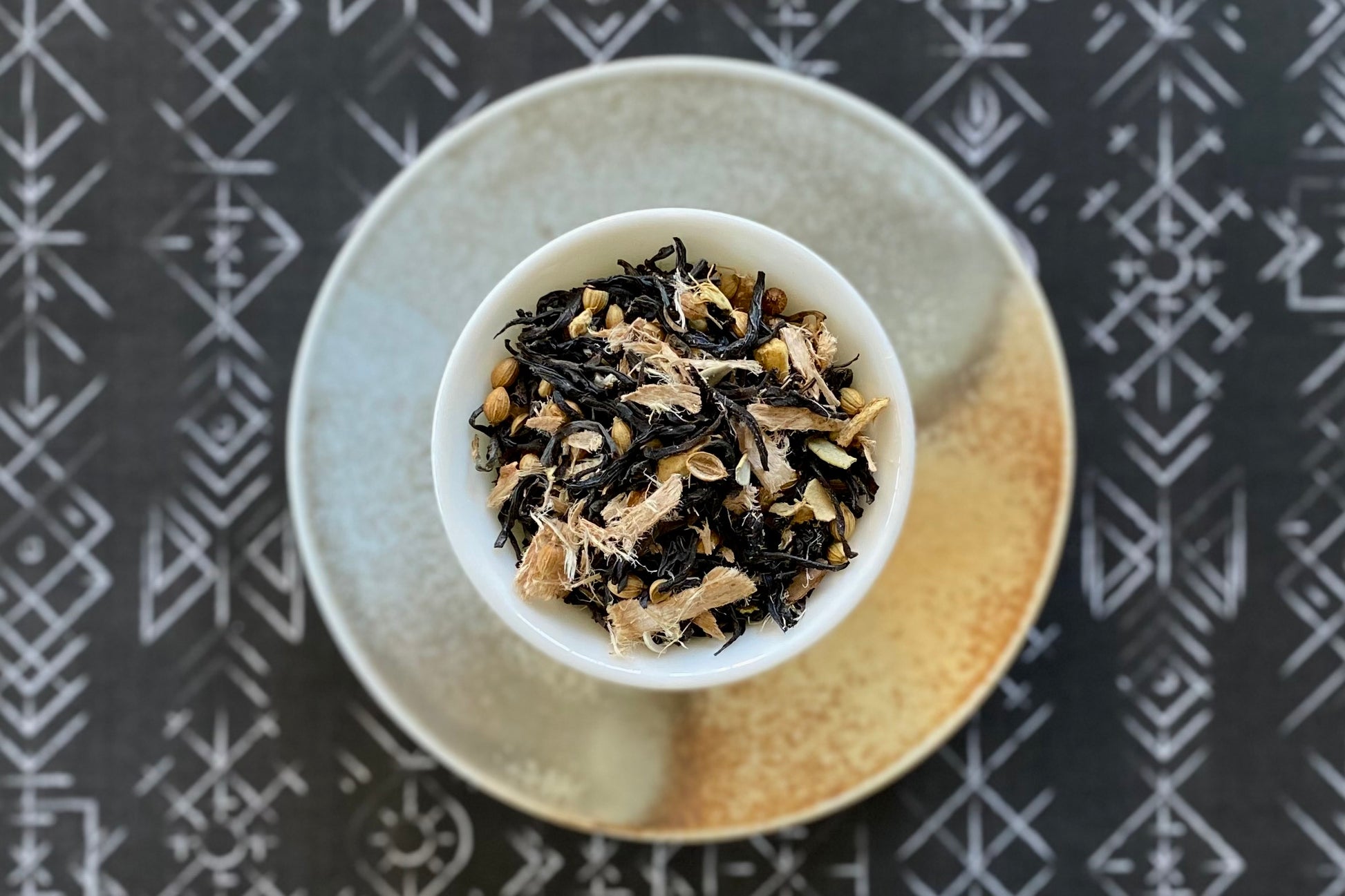 Teacup full of tea leaves and spices