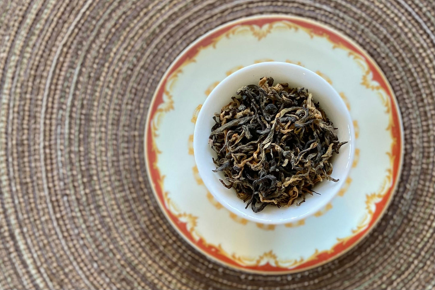 Teacup full of gold-tipped black tea