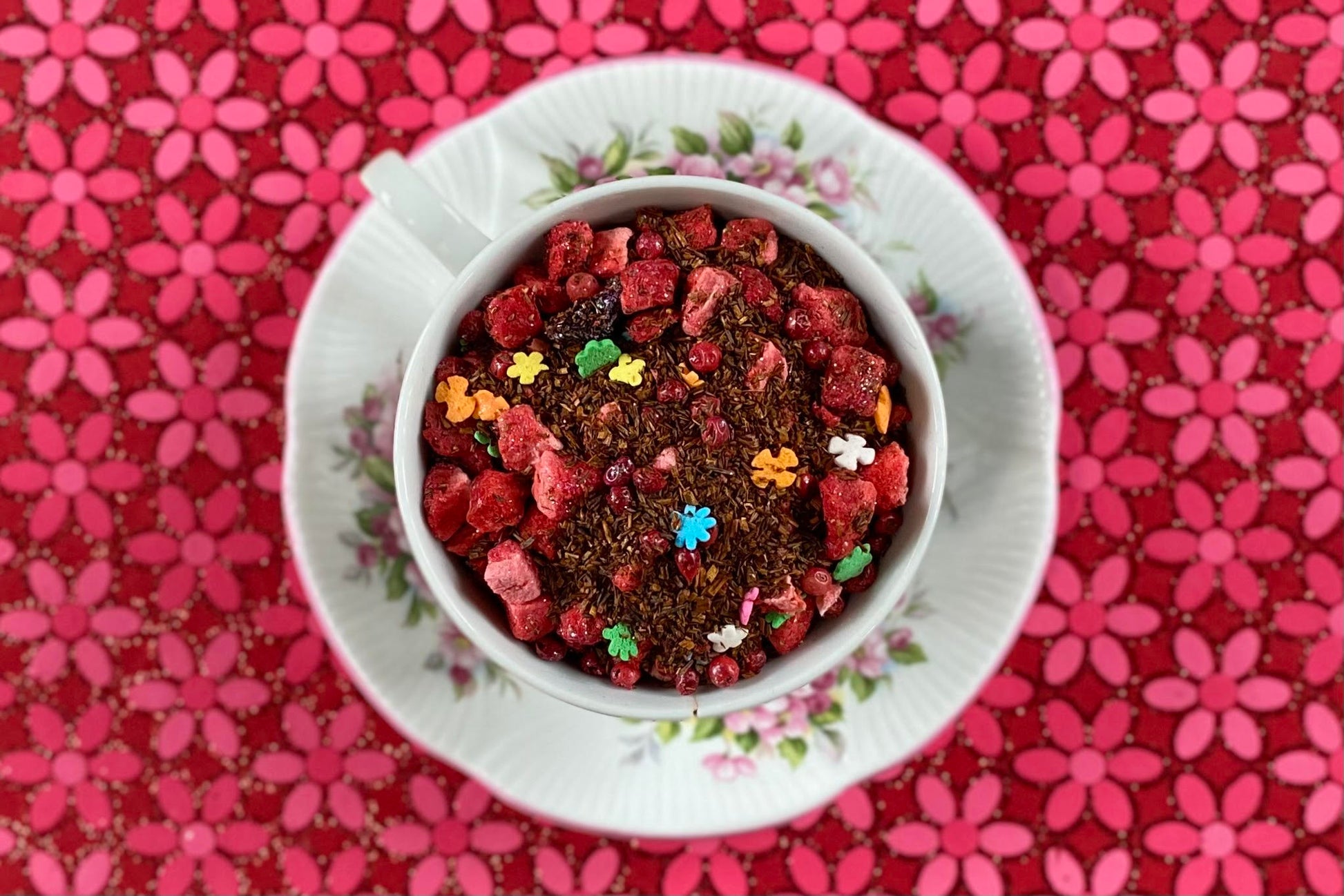 teacup full of rooibos, strawberry, pink pepper and sprinkles