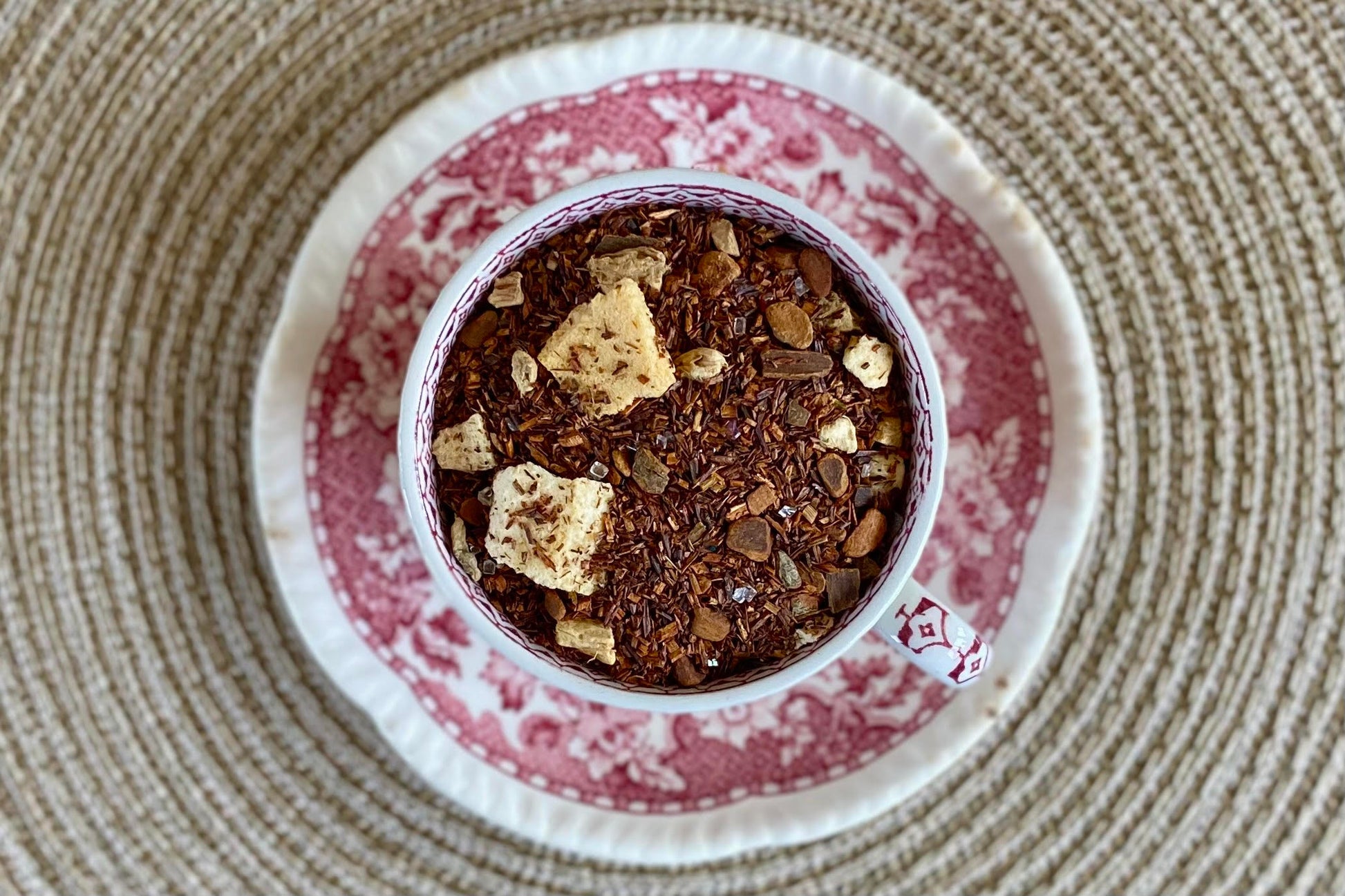 teacup full of rooibos, spices, and peach pieces