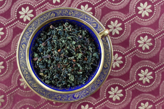 teacup full of rolled oolong and spices