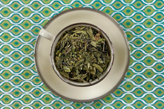 teacup full of tea and mint leaves