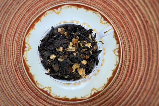 Teacup full of dark oolong leaf and spices